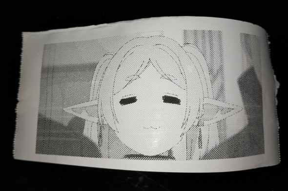 foto of the output of the thermal printer, showing Frieren's face