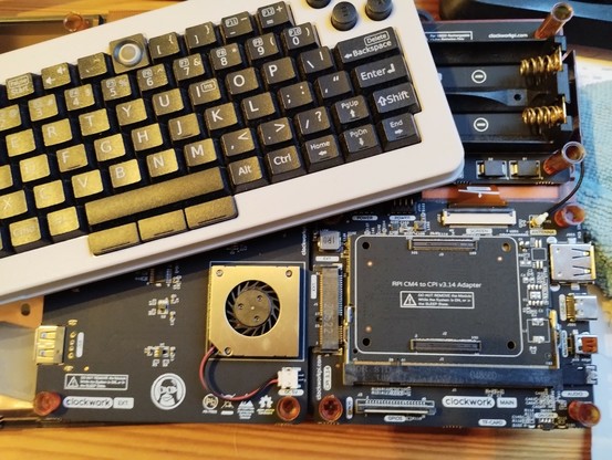 disassembled DevTerm showing the mainboard. it already has the adapter board inserted, missing the compute module.