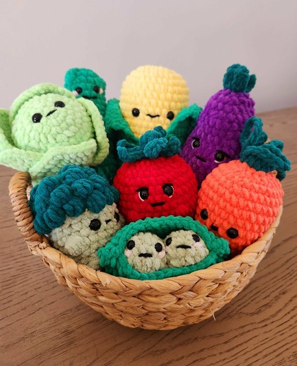 Basket of crochet vegetables. Tomato, broccoli,  pickle, corn, eggplant, peas in a pod, cabbage, carrot