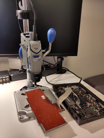 The Dremel-based drilling setup and the C116 on the workbench.