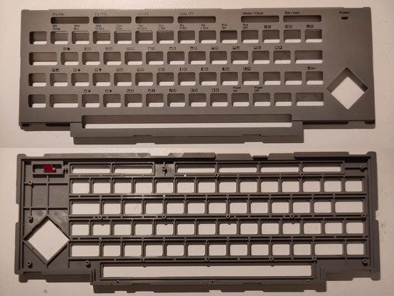 A combined photo of the two sides of the gray plastic Commodore 116 keyboard frame, that shows the result of the drilling on the backside at the bottom, and the visually unchanged front face at the top.