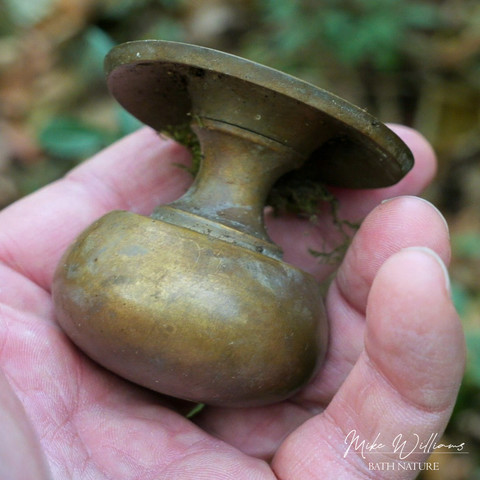 A brass doorknob in a hand A brass doorknob in a hand