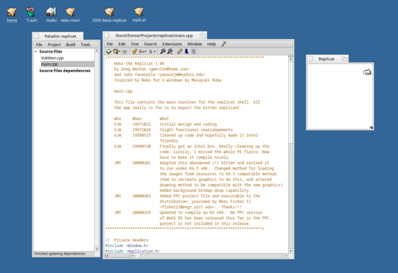 A screenshot of a Haiku desktop. An IDE known as "Paladin" is open, with the source code to replic on display. A window is open to the right, featuring a sleeping net kitten.
