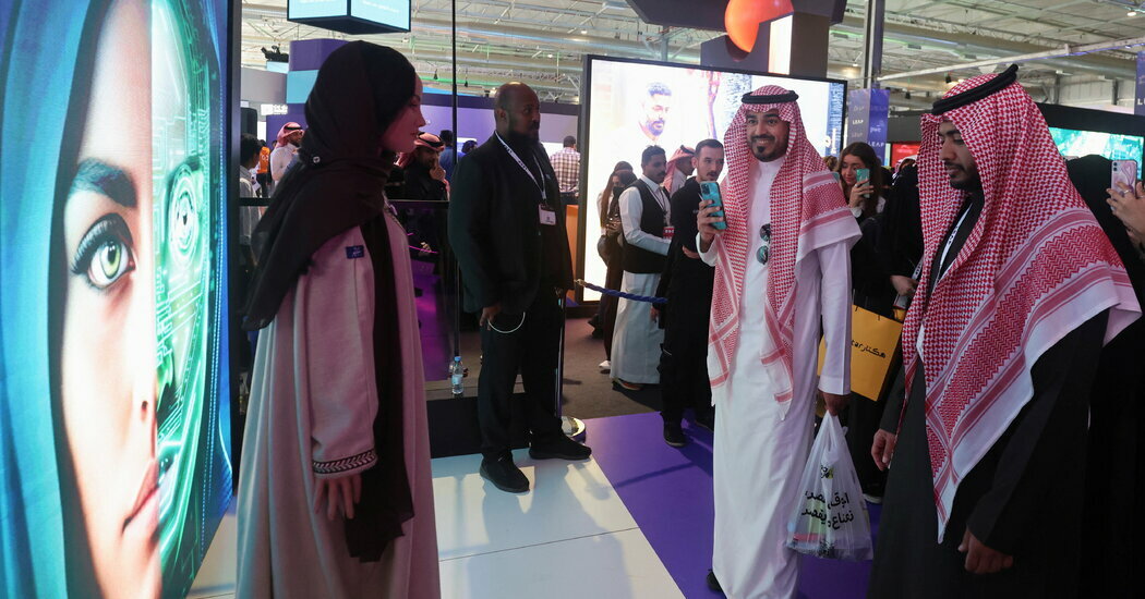 Visitors interact with Saudi Arabia’s first robot “Sara”, at the LEAP conference in Riyadh, February 8, 2023.