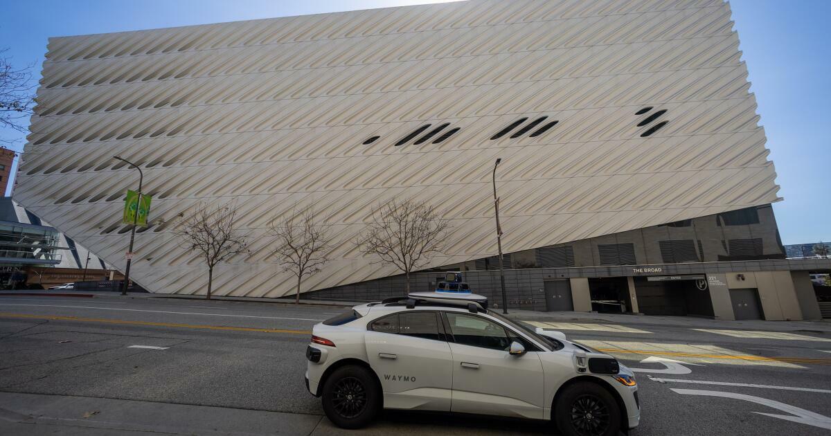 Los Angeles, CA - March 11: (EDS NOTE-NEWS EMBARGO UNTIL WEDNESDAY) A Waymo robotaxi Jaguar I-PACEs driverless car parks next to The Broad in downtown Los Angeles Monday, March 11, 2024. Waymo is about to announce the release of their robotaxi fleet across Los Angeles. The new service will allow users to go from downtown to Santa Monica, covering hundreds of miles. The service is expected to start this week but won't be available for all for a few more weeks. Waymo One fleet consists of fully electric Jaguar I-PACEs - the world's first premium electric autonomously driven vehicle. The Waymo Driver uses fully autonomous technology that is always in control of the vehicle from pickup to destination. (Allen J. Schaben / Los Angeles Times)