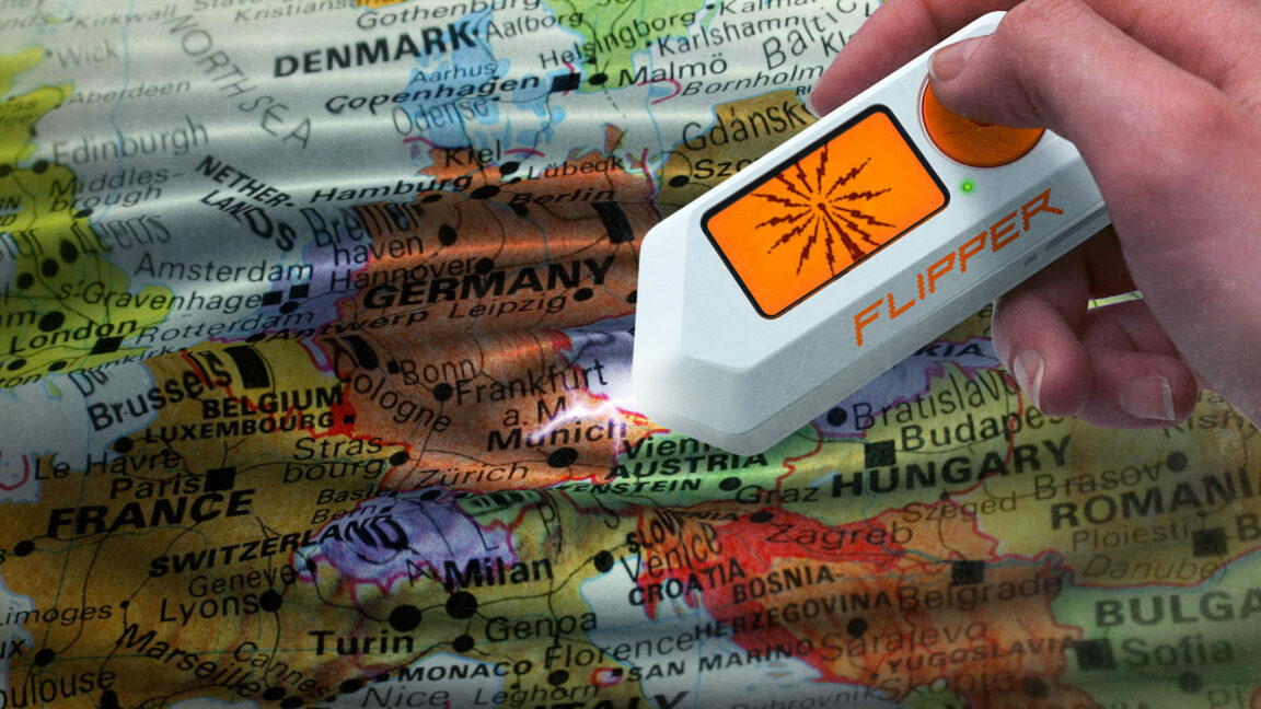 A hand holding a Flipper Zero causes a map of Europe to ripple A hand holding a Flipper Zero causes a map of Europe to ripple