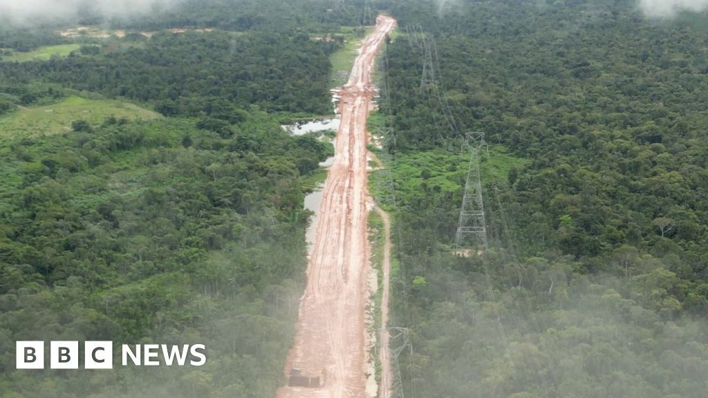 Partially built highway cuts through the rainforest, image taken from drone