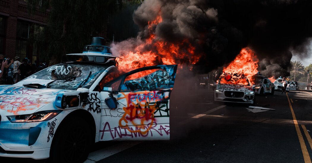 A Waymo self-driving car was vandalized and set on fire at a protest in Los Angeles on Sunday.